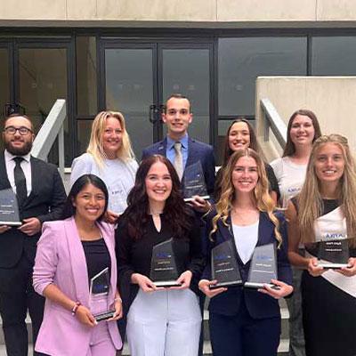 students from the FBLA club hold up awards